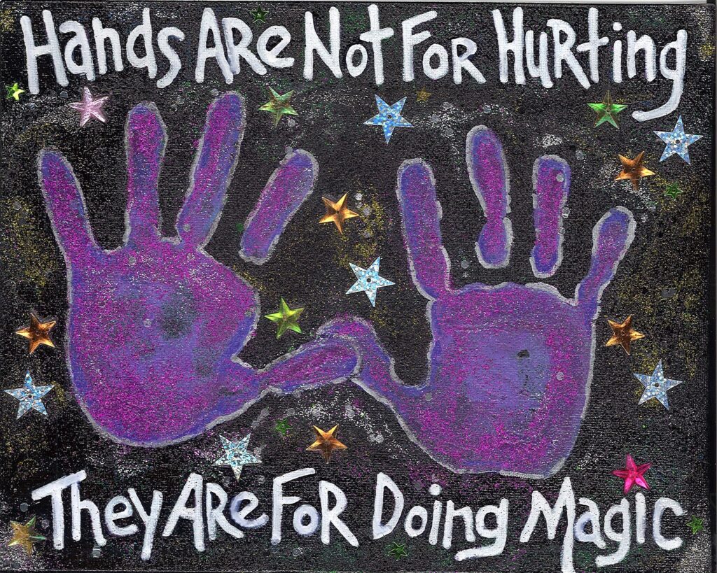 Two purple handprints surrounded by multicolored stars against a dark background, with the inspirational words 'Hands Are Not For Hurting, They Are For Doing Magic' written above and below. The image conveys a message of using our hands for positive, creative, and magical actions instead of harm.